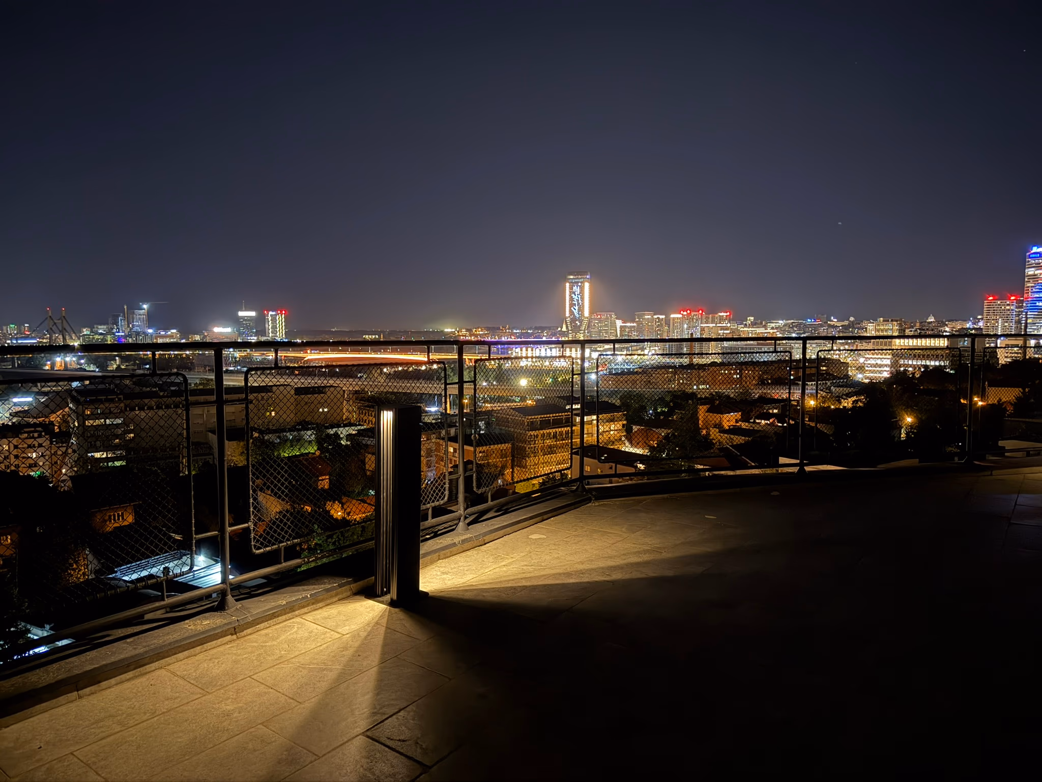 LED Bollard on a rooftop terrace with the city skyline at night